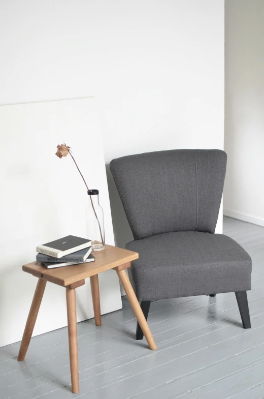 a chair and a table in a room, grey cloth, reading, an aesthetically pleasing, lepra