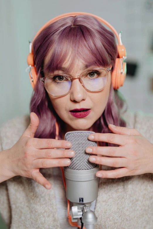 a woman with headphones is singing into a microphone, trending on pexels, antipodeans, in square-rimmed glasses, lilac hair, moe, f4”