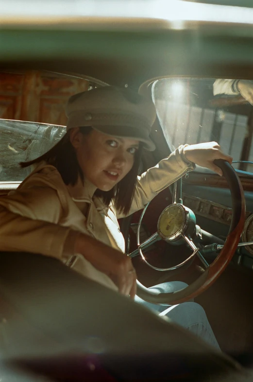 a woman sitting in the driver's seat of a car, inspired by Rudy Siswanto, photorealism, costumes from peaky blinders, under a spotlight, still from a wes anderson film, chinese woman