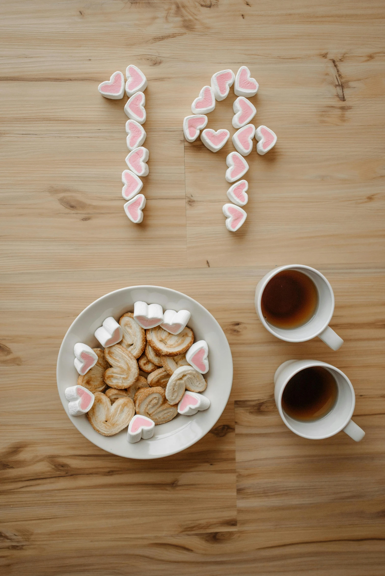 a plate of cookies and a cup of coffee on a table, bunnies, broken hearts, crisp clean shapes, shot with sony alpha