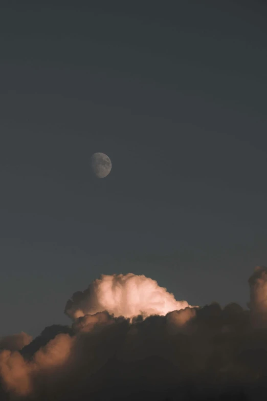 a plane flying through a cloudy sky with the moon in the background, unsplash contest winner, aestheticism, cotton candy clouds, 2019 trending photo, ☁🌪🌙👩🏾, dark towering clouds