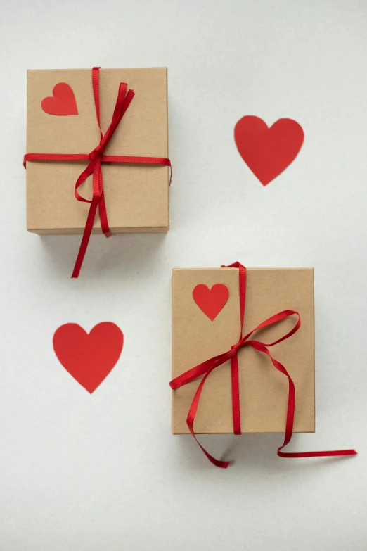 a couple of boxes sitting on top of a table, featured on pinterest, red hearts, full product shot, square sticker, low detail