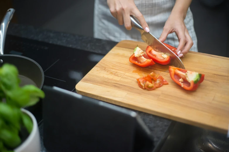 a person cutting tomatoes on a cutting board, by Julia Pishtar, using a macbook, no - text no - logo, tech demo, pepper