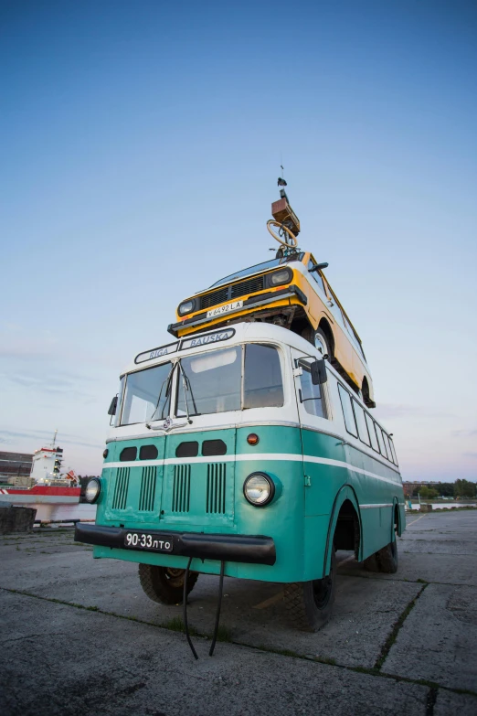 a green and white bus sitting on top of a parking lot, by Sven Erixson, happening, tallinn, yellow, port, museum quality photo