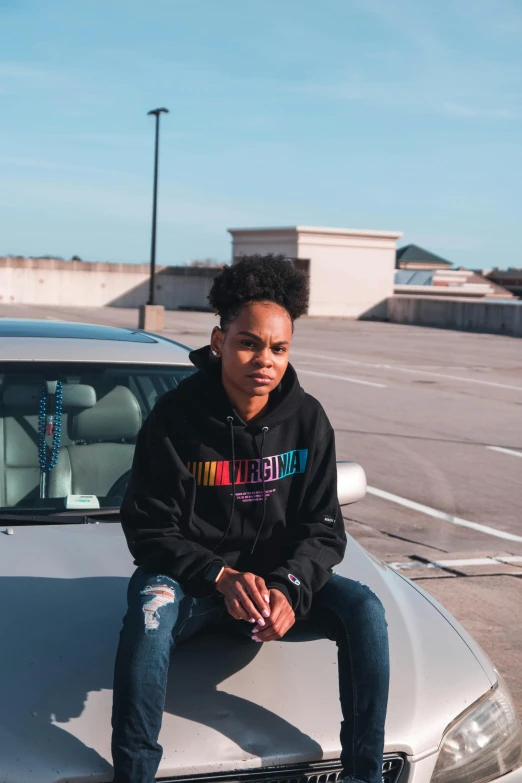 a man sitting on the hood of a car, an album cover, by Winona Nelson, trending on unsplash, non binary model, light skin, taken on iphone 14 pro, roygbiv