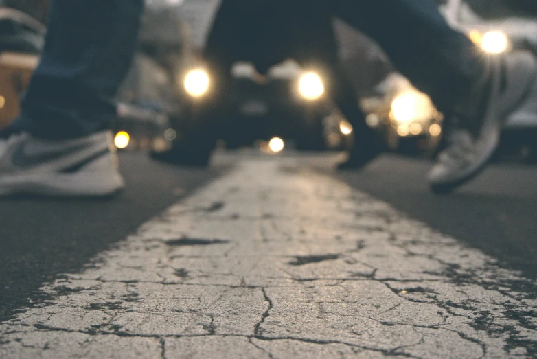 a group of people walking down a street at night, an album cover, pexels contest winner, crawling on the ground, cracks, background image, crosswalks