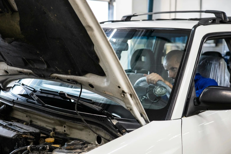 a man working on a car in a garage, a portrait, unsplash, avatar image, broken down, 15081959 21121991 01012000 4k, organic detail