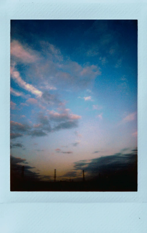 a polaroid picture of a blue sky with clouds, a polaroid photo, by Nathalie Rattner, large twin sunset, pylons, on flickr in 2007, vertical movie frame