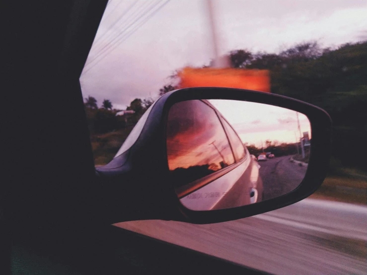 a rear view mirror on the side of a car, pexels contest winner, orange tint, tumblr aesthetic, driving fast, polaroid effect