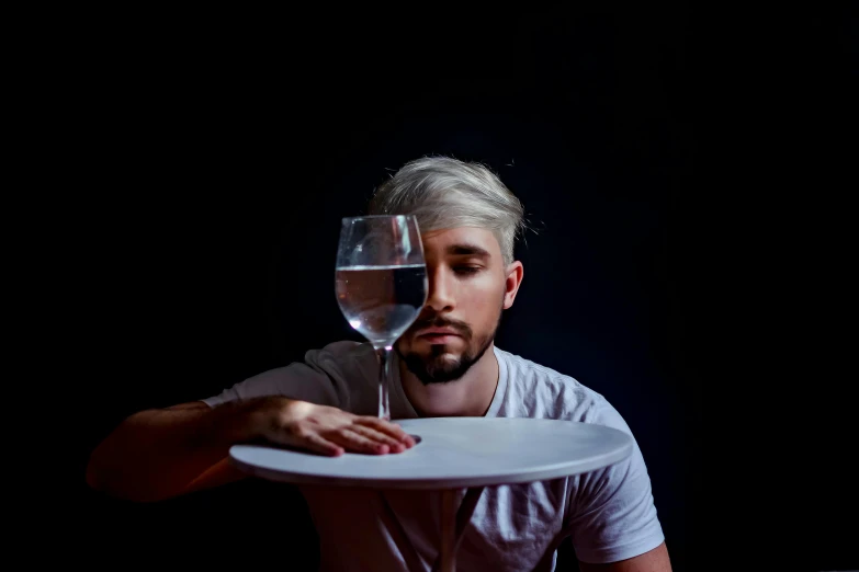 a man holding a plate with a glass of wine on it, inspired by Jan Lievens, pexels contest winner, albino hair, trapped egos in physical reality, filling with water, jacksepticeye