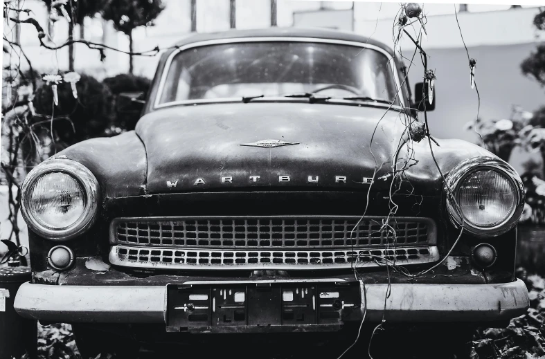 a black and white photo of an old car, a black and white photo, by Adam Marczyński, pexels contest winner, photorealism, covered with wires, album cover, soviet nostalgia, ready - made