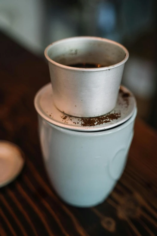 a couple of cups sitting on top of a wooden table