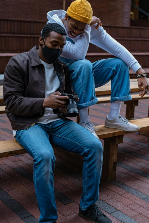 a couple of men sitting on top of a wooden bench, trending on pexels, baggy jeans, game ready, black man, professional iphone photo