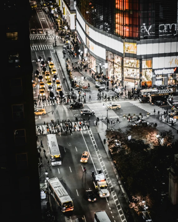 an aerial view of a busy city street at night, pexels contest winner, happening, watching new york, thumbnail, low quality photo, billboard image