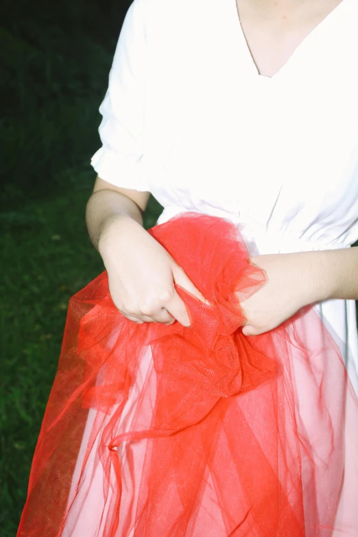 a woman in a white shirt and red skirt, inspired by Nan Goldin, unsplash, renaissance, wearing organza gown, detail, rinko kawauchi, summer night