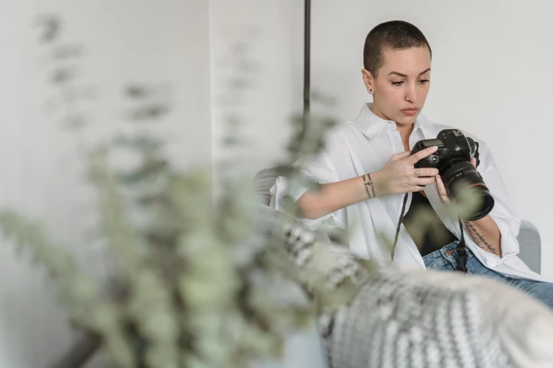 a woman taking a picture of herself in a mirror, a picture, by Emma Andijewska, pexels contest winner, buzz cut hair, portrait of max caulfield, taken with canon 5d mk4, making of