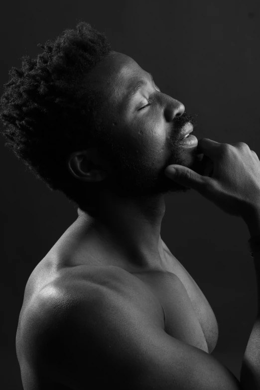 a black and white photo of a man with his hand on his chin, by Clifford Ross, pexels contest winner, afro tech, disrobed, profile pose, childish gambino