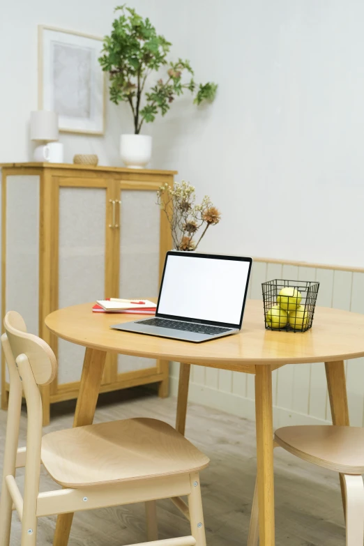 a laptop computer sitting on top of a wooden table, a computer rendering, pexels, dining table, a blond, round design, home display