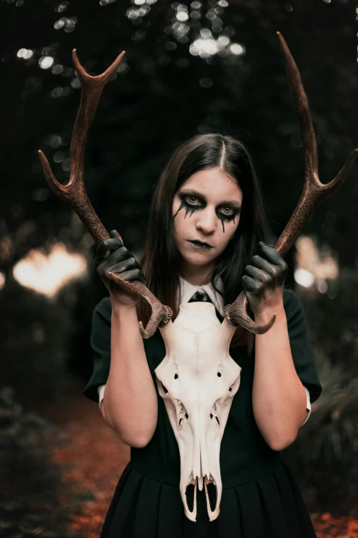 a woman in a black dress holding a deer skull, inspired by Samuel Hieronymus Grimm, pexels contest winner, corpsepaint, professional cosplay, profile image, as wednesday addams