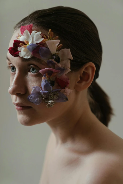 a woman with flowers painted on her face, an album cover, by Elizabeth Polunin, wide film still, ribbon, lachlan bailey, eleven/millie bobbie brown