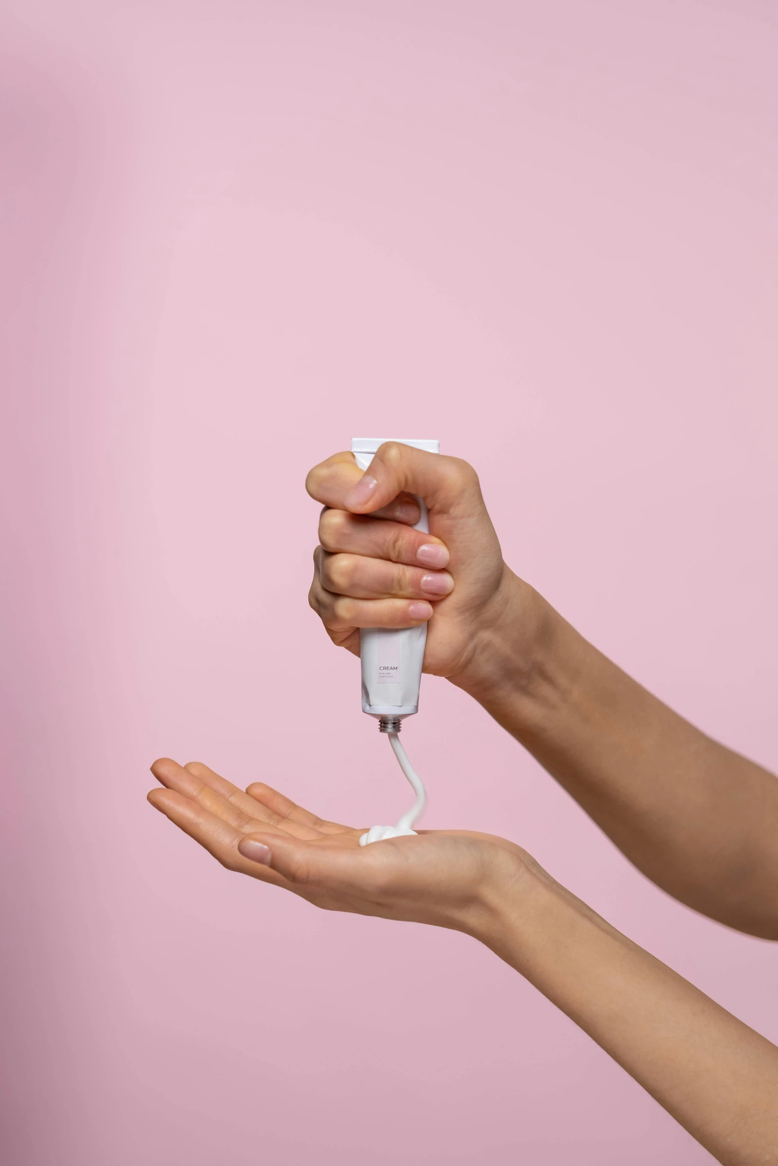 a woman holding a hand sanitizer in her hand, by Olivia Peguero, happening, white and pink, with electric arc device, on a pale background, eye level view