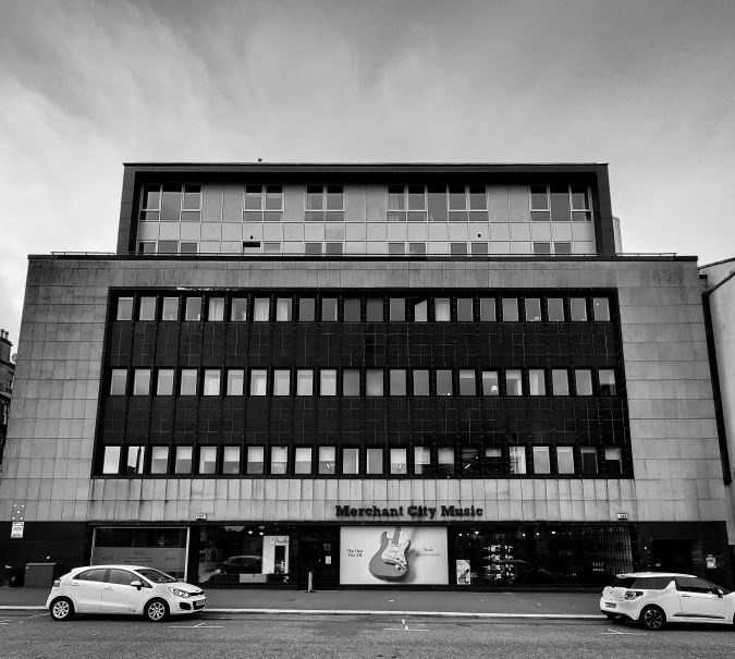 a black and white photo of a large building, by Steve Prescott, merchant street, high quality image, square, whealan