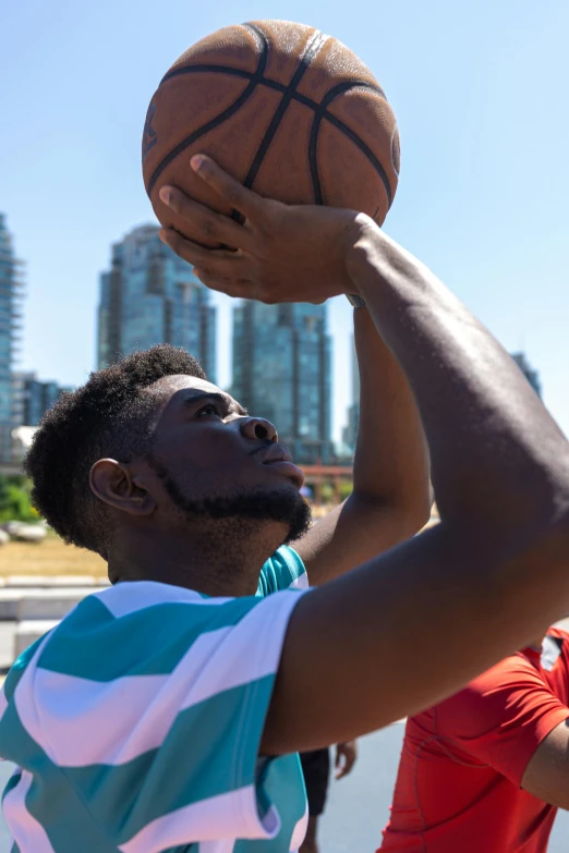 a group of young men playing a game of basketball, an album cover, by Greg Spalenka, pexels contest winner, african canadian, 30 year old man :: athletic, sunny day time, looking from shoulder