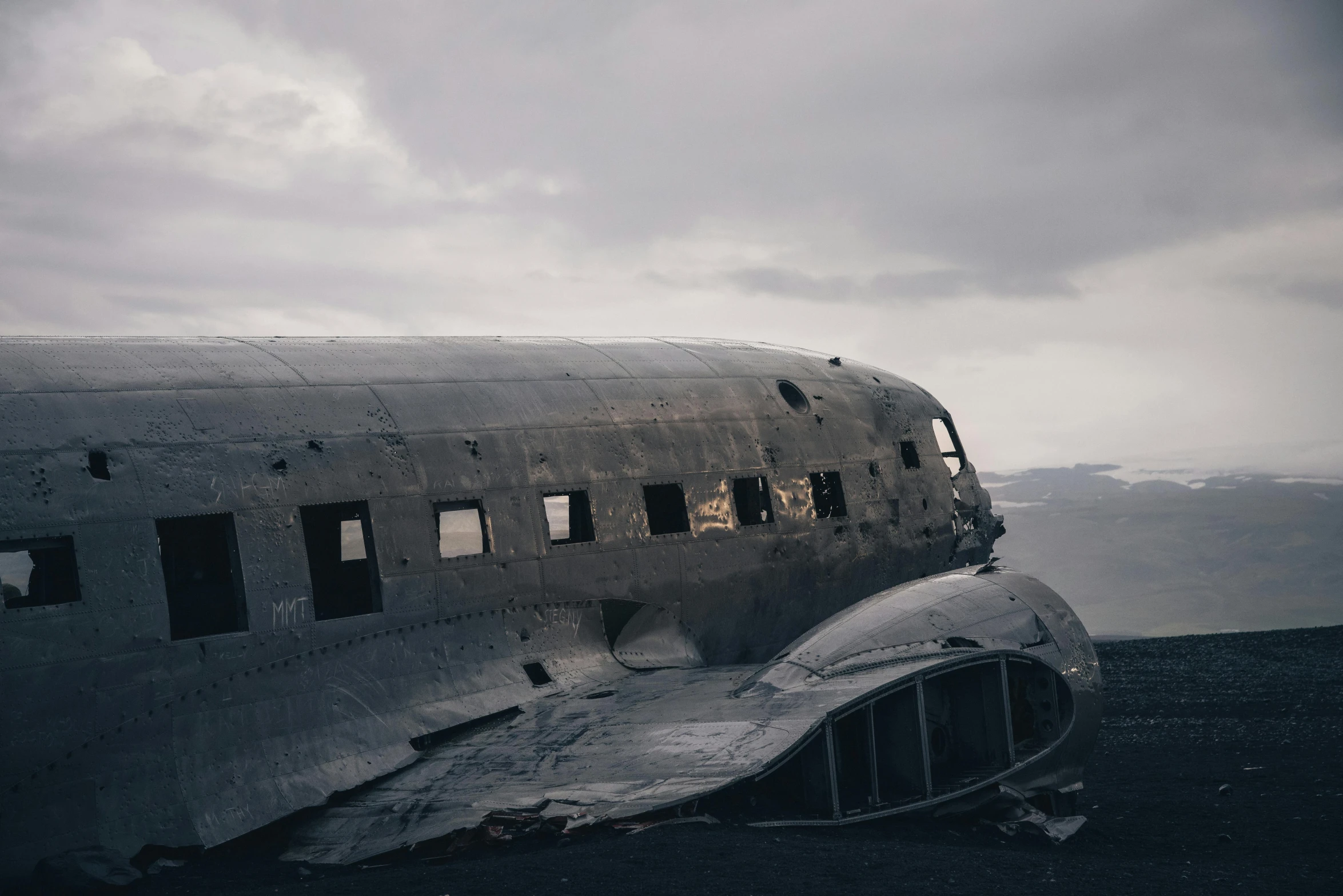 an old airplane sitting on top of a mountain, by Jessie Algie, unsplash contest winner, a ancient crashed spaceship, reykjavik, on a gray background, fuselage