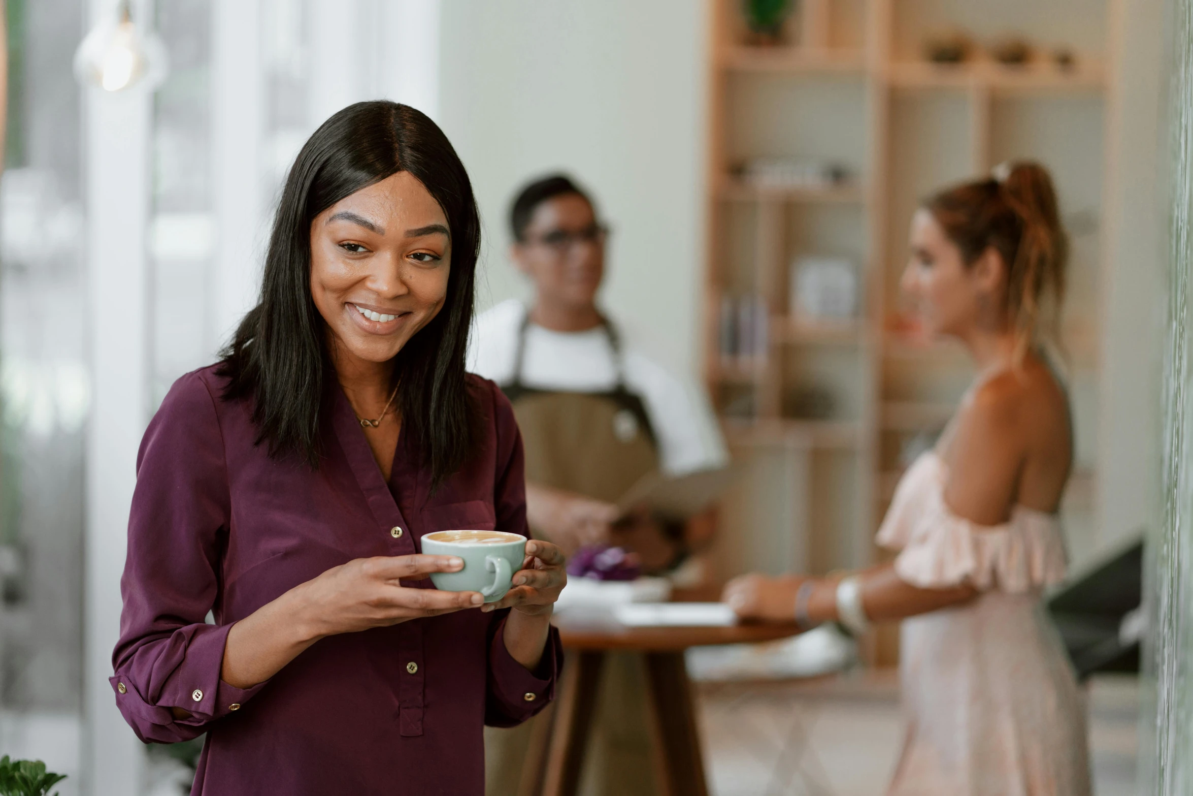 a woman standing in a kitchen holding a cup of coffee, pexels contest winner, renaissance, african american young woman, in a coffee shop, avatar image, people watching around