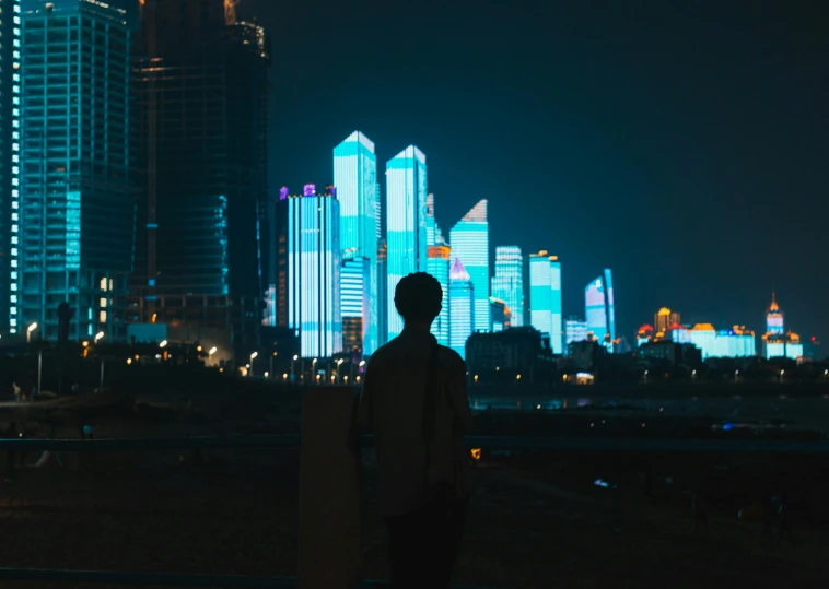 a man standing in front of a city at night, pexels contest winner, pixel art, projection mapping, shenzhen, without text, instagram post