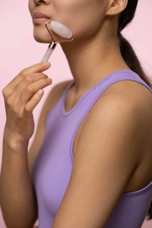 a woman brushing her teeth with a toothbrush, an album cover, trending on pexels, happening, violet tight tanktop, side profile view, pastel pink skin tone, detailed product image