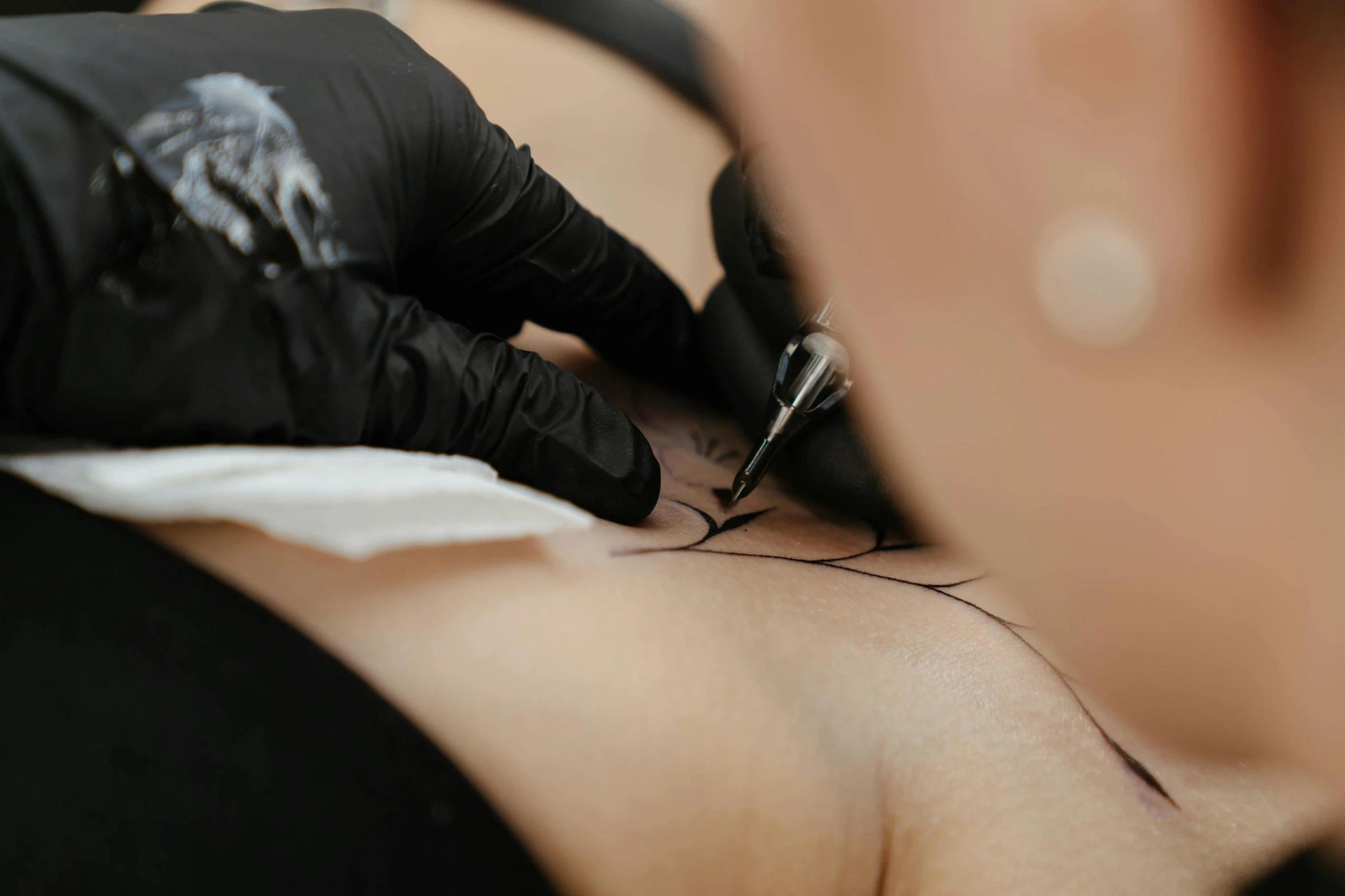a close up of a person getting a tattoo, black outline, te pae, an impeccable beauty, low quality photo