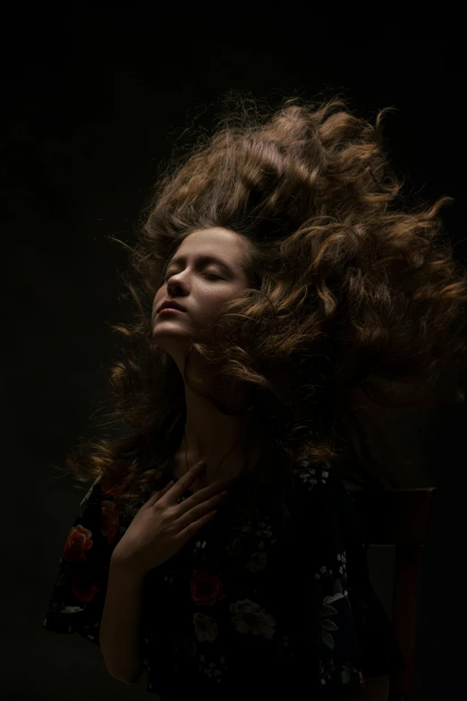 a woman with her hair blowing in the wind, an album cover, inspired by Anna Füssli, pexels contest winner, renaissance, dark. studio lighting, wild ginger hair, ((portrait)), photographed for reuters