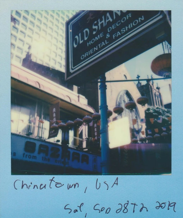 a close up of a street sign with a building in the background, a polaroid photo, by Maggie Hamilton, shin hanga, chinatown bar, ((blue)), album cover art, olmsted
