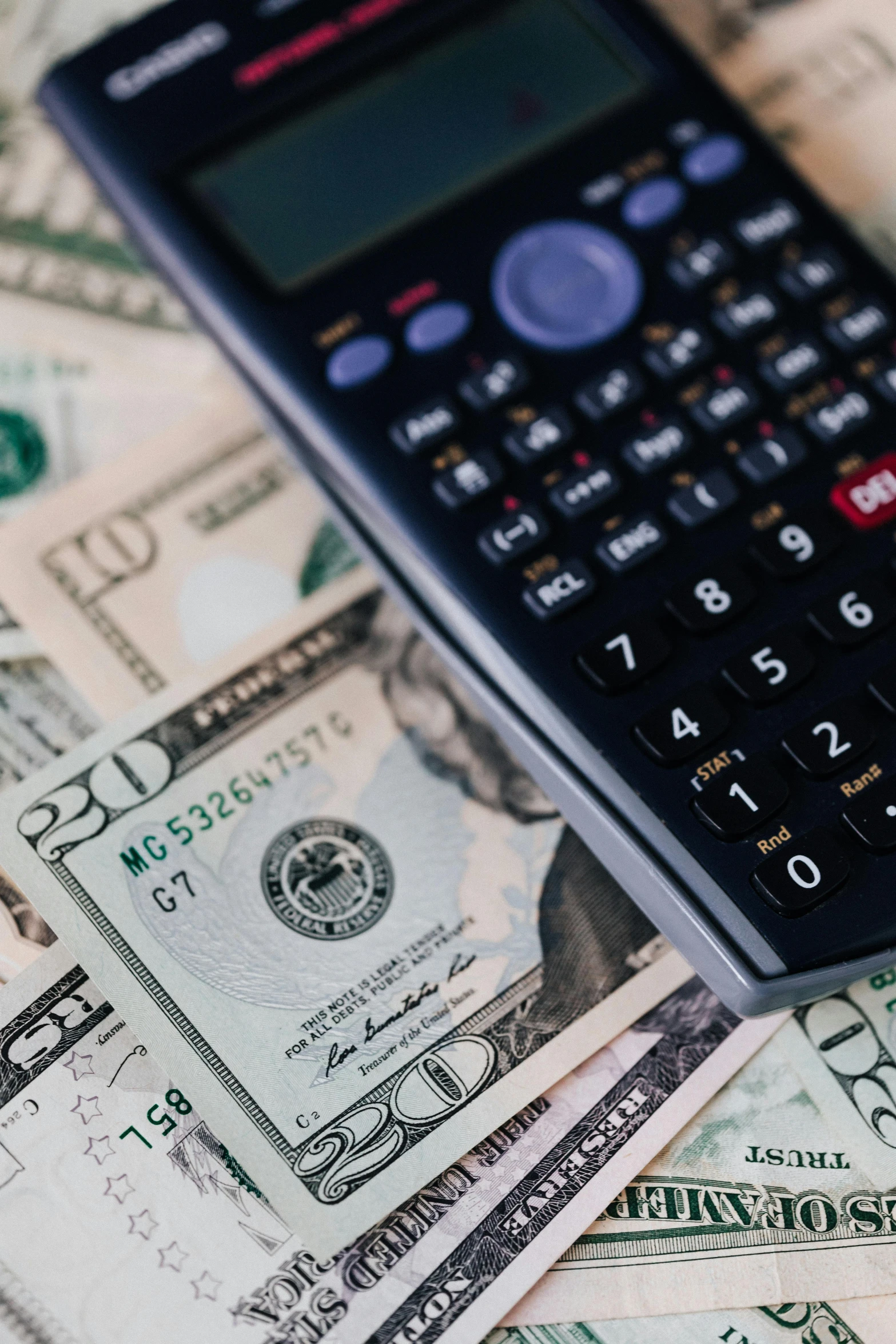 a calculator sitting on top of a pile of money, by Matt Cavotta, pexels, renaissance, 🚀🌈🤩, instagram post, multiple stories, usa