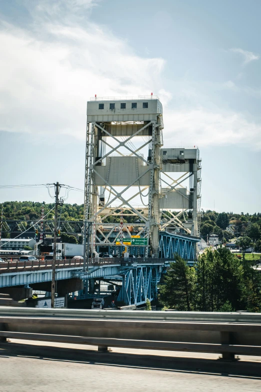 a bridge with a train going over it, lookout tower, lynn skordal, medium shot taken from behind, towering