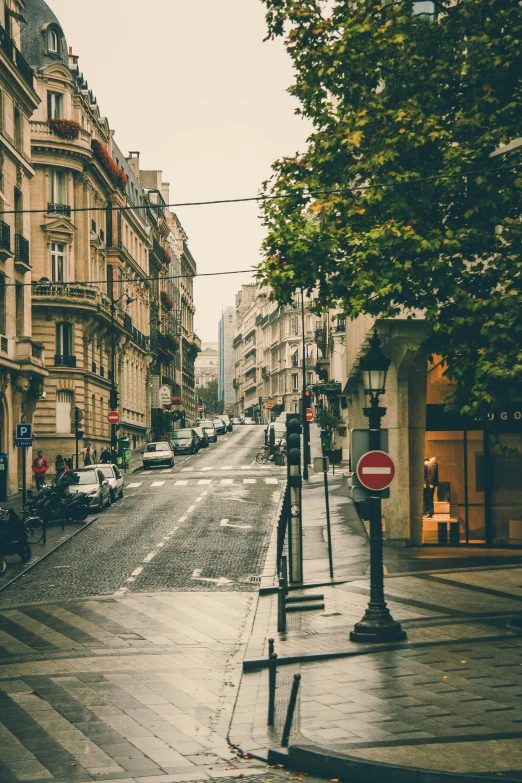 a street filled with lots of traffic next to tall buildings, unsplash contest winner, paris school, empty streetscapes, rainy day outside, french village exterior, uncropped