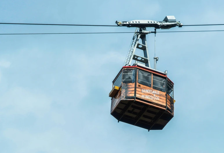 a cable car is suspended in the air, by Niko Henrichon, pexels contest winner, viennese actionism, brown, print ready, super high resolution, helvetica