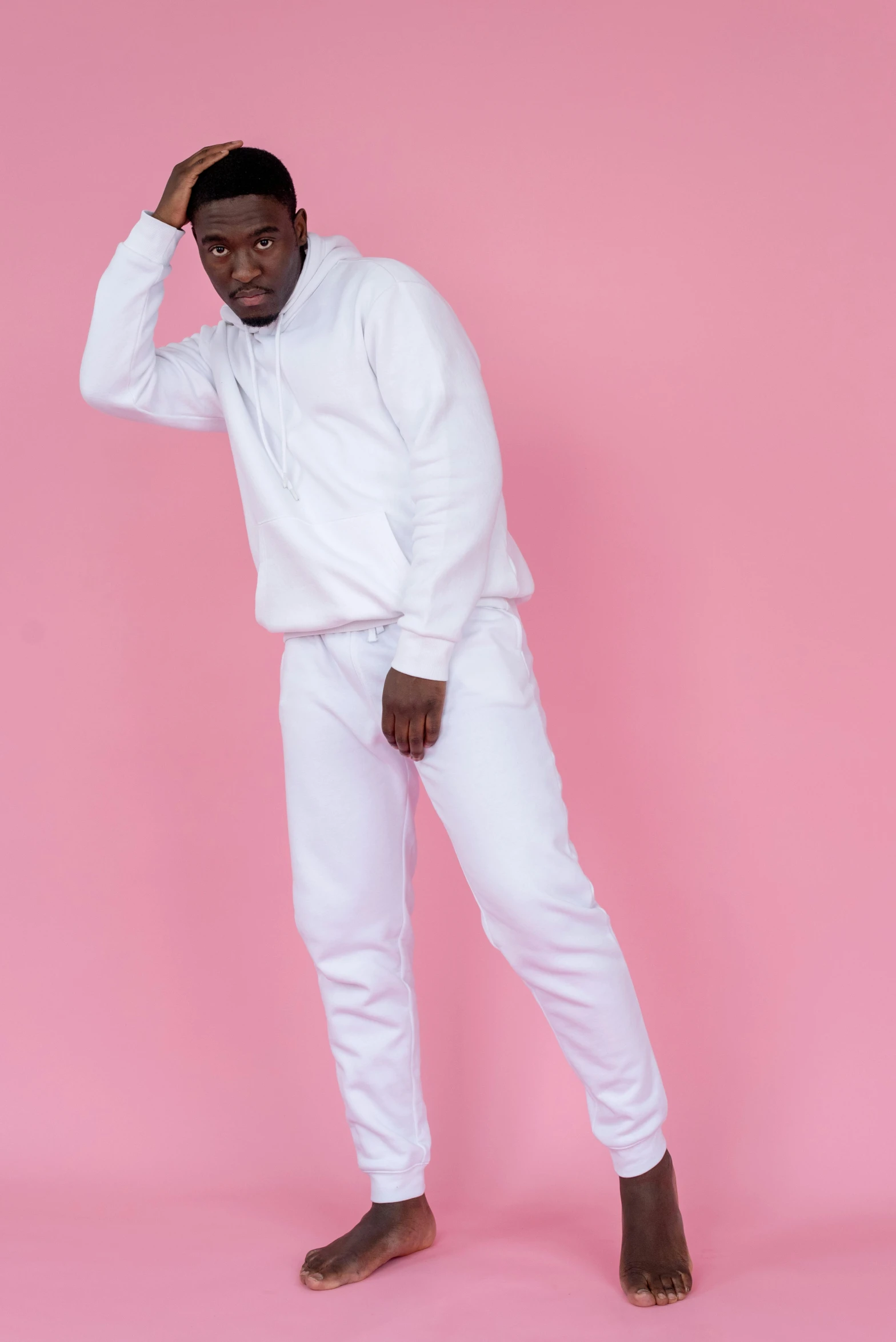 a man in a white shirt and white pants, trending on pexels, wearing a tracksuit, ( ( dark skin ) ), whitespace, made with photoshop