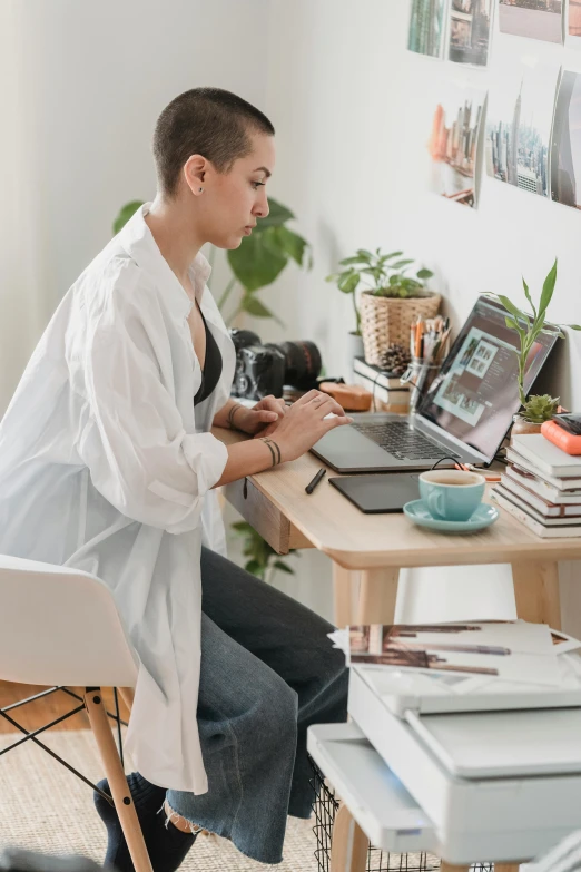 a woman sitting at a desk using a laptop computer, a picture, trending on pexels, arbeitsrat für kunst, wearing a white lab coat, apartment of an art student, outfit photograph, stacked image