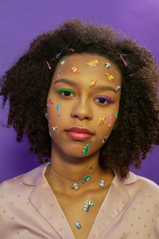a woman with sprinkles on her face, an album cover, inspired by Howardena Pindell, trending on pexels, hyperrealism, purple skin, puffy sticker, black teenage girl, covered in circuitry