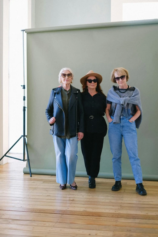 three women standing next to each other in a room, unsplash, photorealism, wearing sunglasses and a hat, duane hanson, wearing a jeans jackets, older woman