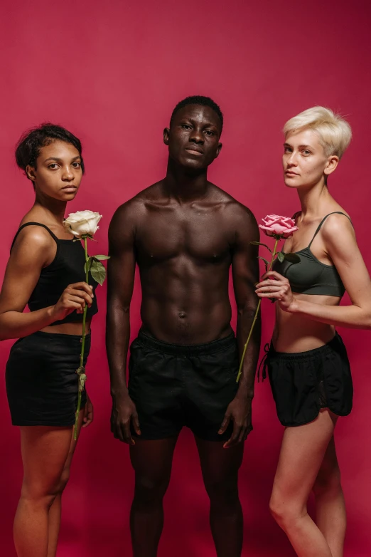 a man and two women standing next to each other, by Jessie Alexandra Dick, pexels contest winner, black boy shorts, roses, cropped red yoga short, ukrainian