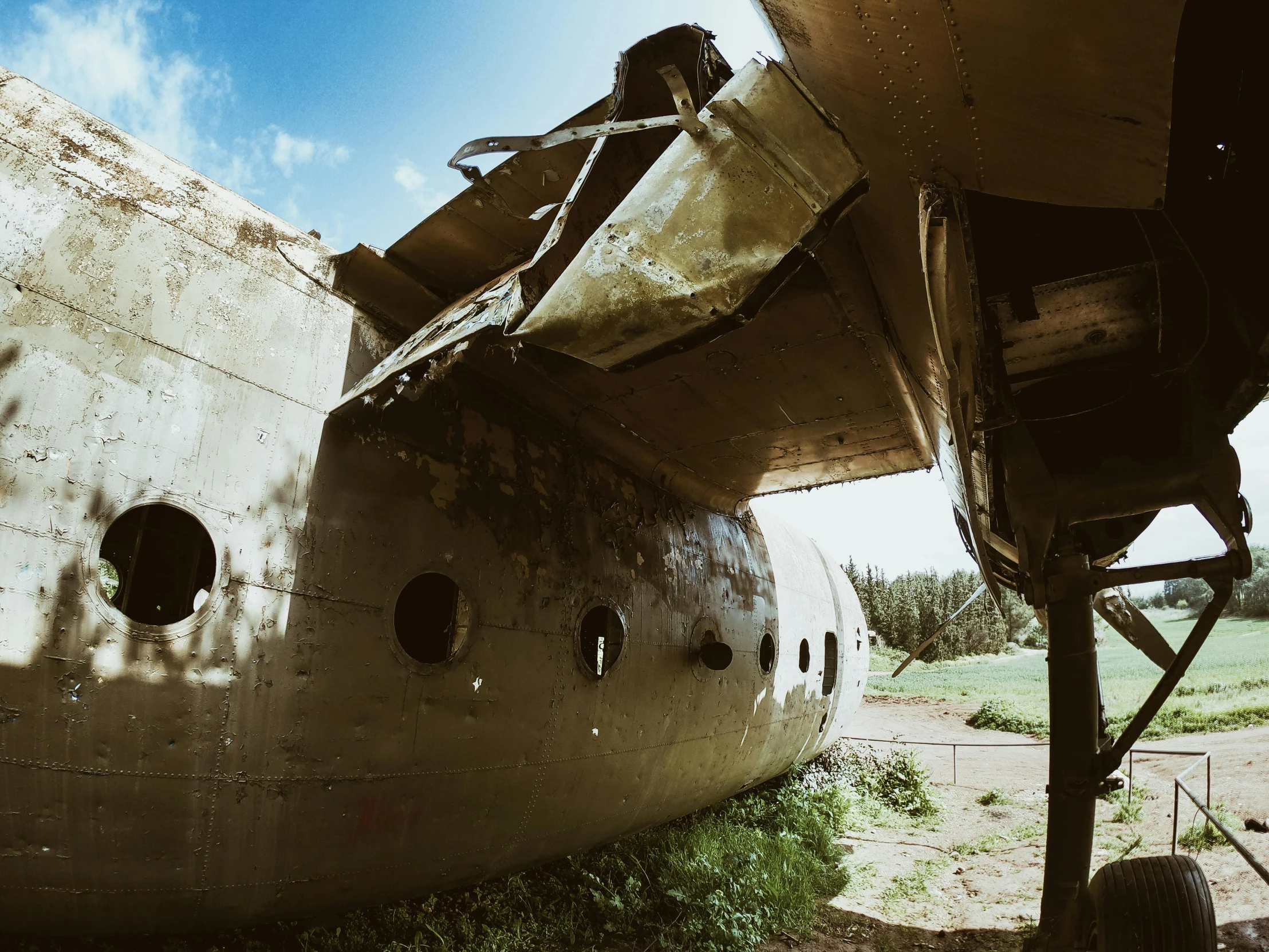 a large airplane sitting on top of a grass covered field, by Filip Hodas, pexels contest winner, inside abandoned space ship, 1940s photo, very low angle view, slide show