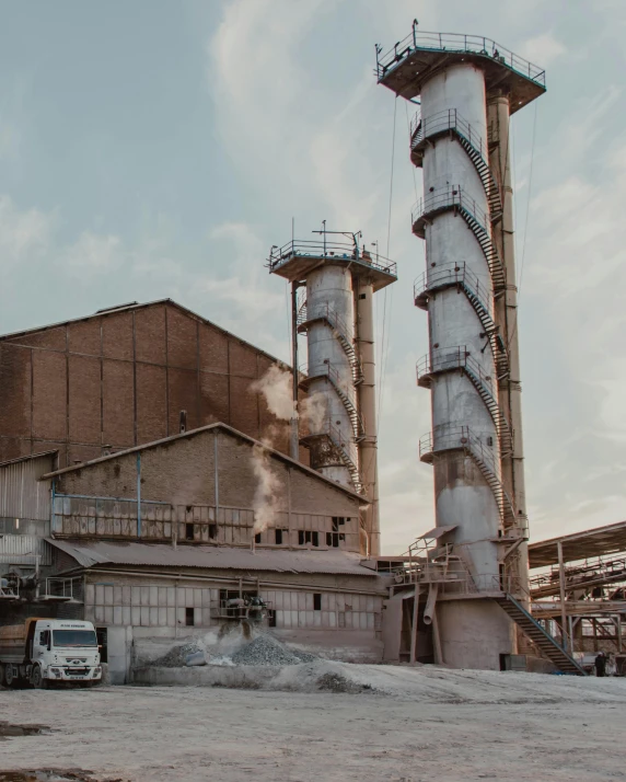 a truck is parked in front of a factory, pexels contest winner, renaissance, clay material, tall structures, grey, production ready