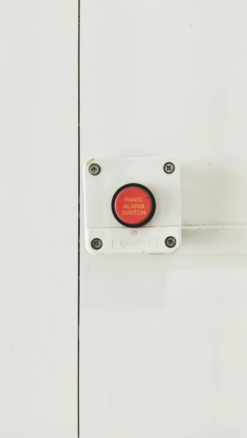 a close up of a red button on a white door, a cartoon, unsplash, ffffound, worksafe. instagram photo, product view, high - angle view