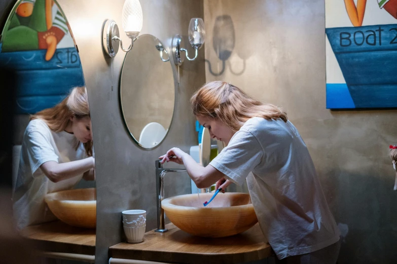 a woman washes her hands in a bathroom sink, pexels contest winner, elle fanning at a diner, nina tryggvadottir, ocean dept, profile image