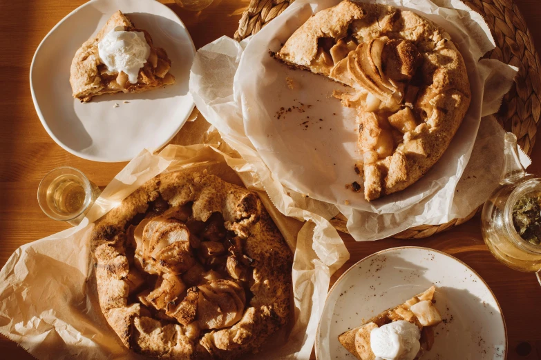 a table topped with plates of pies and glasses of wine, a still life, unsplash, renaissance, apple pie, parchment paper, thumbnail, 3 - piece