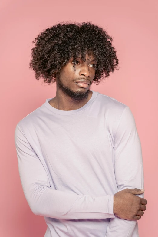 a man with curly hair standing in front of a pink background, inspired by Theo Constanté, trending on pexels, grey backdrop, dark chocolate hair colour, purple skin color, male model