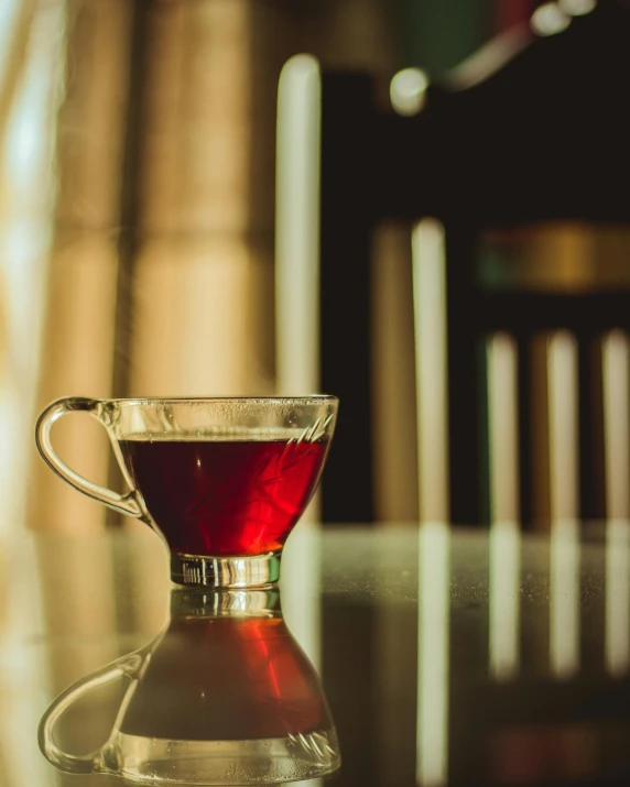 a cup of tea sitting on top of a glass table, red hues, non-binary, thumbnail, fan favorite